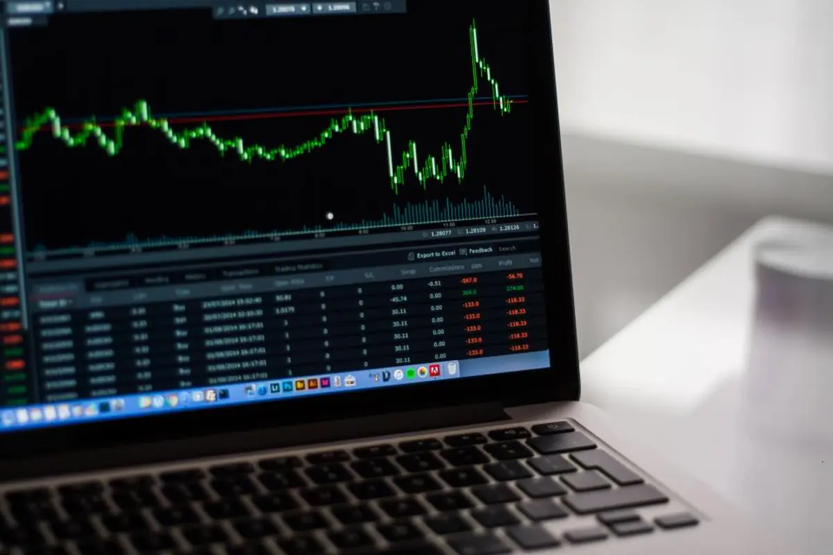 Laptop showing a rising chart, representing the return on a property management website