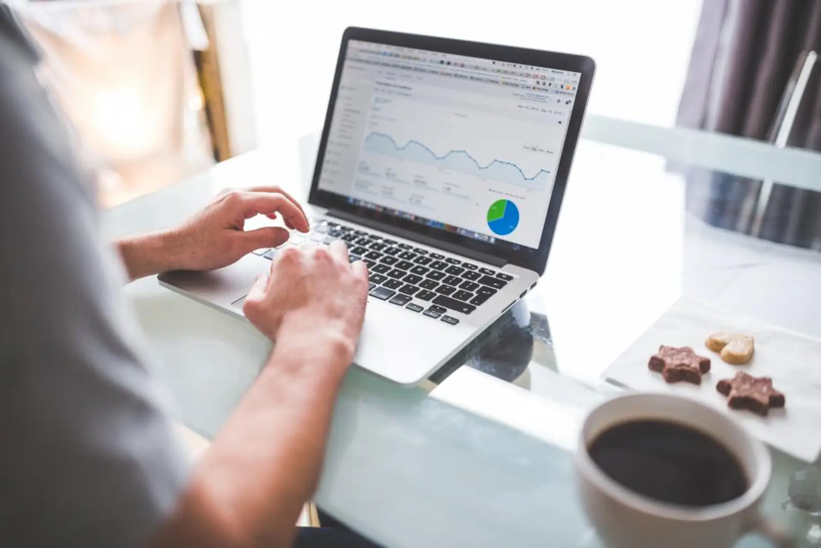 Property manager reviewing website analytics and lead data on a laptop